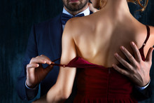 Elegant Couple In Love. Rich Tidy Neat Man Male Hugs Luxury Woman Female In Red Evening Dress With Expensive Gold Earrings. Romantic Dating Body Part, Sex Social Issues, Relationship Concept
