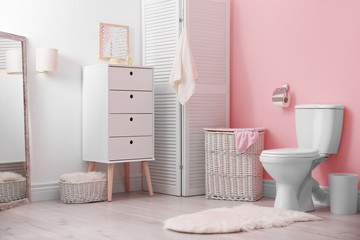 Toilet bowl in modern bathroom interior