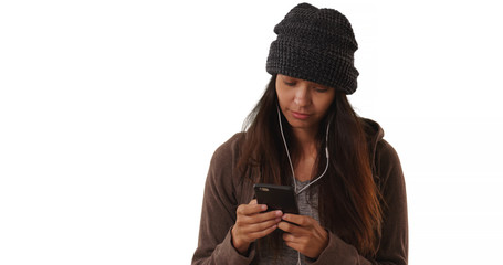 Wall Mural - Millennial girl listens to music streaming app with smartphone white background