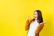 © torwaiphoto - Asian girl is surprised she is excited.Yellow background studio