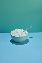 Bowl Filled With Sugar Cubes And Spoon