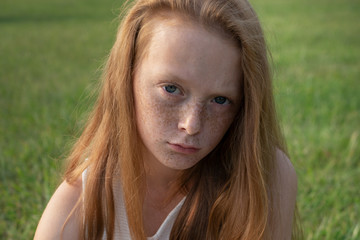 sad little girl looking in camera with unhappy eyes