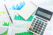 © zodar - Calculator and Pen with Business Graphs finance document.
