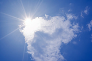 Wall Mural - blue sky with clouds and sun reflection.the sun shines bright in the daytime in summer