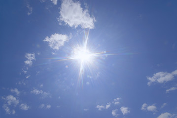 Wall Mural - blue sky with clouds and sun reflection.the sun shines bright in the daytime in summer