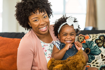 African American family. Mother and daughter smiling at home.