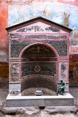 Wall Mural - House of the Small Fountain ,Casa della Fontana piccola, with fountain decorated with mosaics in the ancient roman city of Pompeii destroyed by the eruption of Mount Vesuvius in 79 A.D.