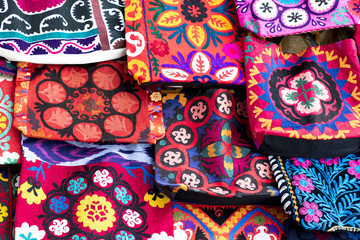 market stalls with decorative tribal textile with colourful pattern made in central asia, uzbekistan