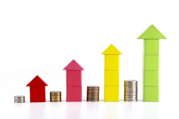 Stacks of coins and graphs from a wooden box on a white background.