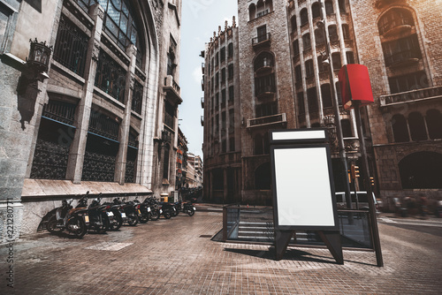 Fotografie, Obraz Vertical empty billboard placeholder template on the street with multiple motorb