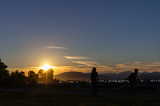 Fototapeta  - Person enjoying sunset, Kitsilano Beach Park, Vancouver, BC, Canada.