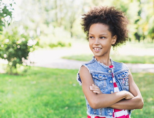 Wall Mural - Beautiful kid girl portrait outdoors.  Healthy smiling little girl enjoying life.  Relaxing in nature, summer holidays concept