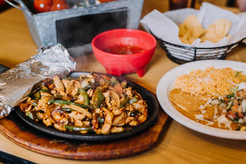 Wall Mural - Chicken fajitas with rice, beans ,chips and salsa