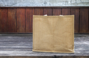 Wall Mural - Empty jute grocery bag on wooden floor, natural fiber bag, ecological product