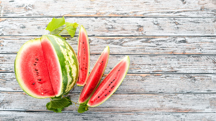 Fresh ripe watermelon. Melon. On a white wooden background. Free space for text. Top view.