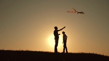 A Happy Family. Family In The Summer At Sunset Launch A Kite Into The Sky.