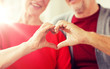 © Syda Productions - relationships, love and old people concept - close up of senior couple showing hand heart gesture