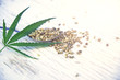 hemp leaves on wooden background, seeds, cannabis oil extracts jars