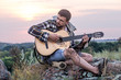 © puhimec - Guy with guitar play songs at sunny nature