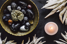 Mixed Stones And White Sage With Lit Candle