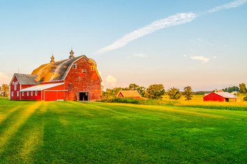 the sun begins to set on a farm in minnesota