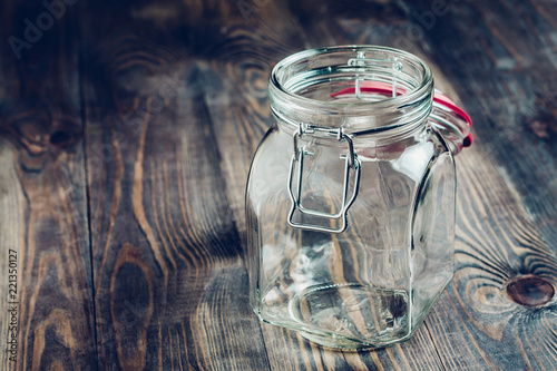 Empty glass jar on a wooden table - utensils for food Tableau sur Toile