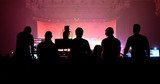 Fototapeta Tęcza - Sound and lighting technicians and the crowd in a concert