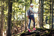 © Novak - Active female hiker walking and exploring forest