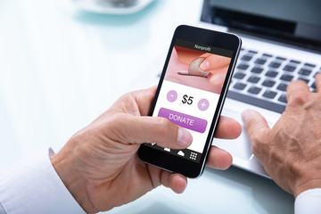 Businessman Donating Money Online On Mobile Phone