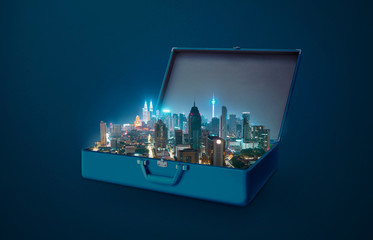 Night scene modern city in an open retro vintage suitcase isolated on blue background .