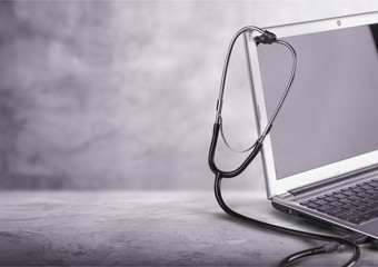 Poster - Laptop diagnosis with  stethoscope  on background