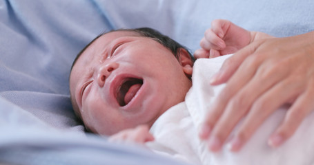 Poster - New born baby crying with hand comforting