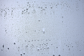 gray wet background / raindrops to overlay on the window, weather, background drops of water rain on the glass transparent