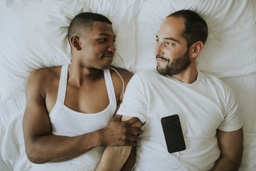 Wall Mural - Couple listening to music in bed