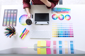 Poster - Image of female creative graphic designer working on color selection and drawing on graphics tablet at workplace, top view workspace