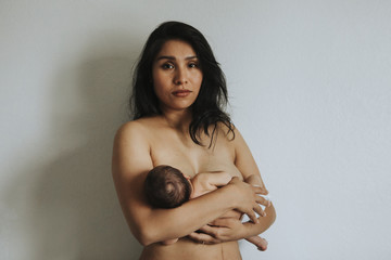 Wall Mural - naked mother holding her newborn baby