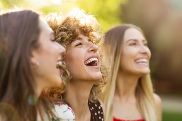 Wall Mural - group of three female friends having fun together