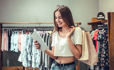 Wall Mural - Shopping girl with shopping bags. beautiful woman in the store.