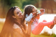 © Martinan - Mother and daughter having fun in park