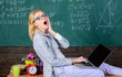 Woman tired teacher work laptop classroom chalkboard background. Working conditions which prospective teachers must consider. Work far beyond the actual school day. Working conditions for teachers