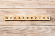 bookkeeping word written on wood block. bookkeeping text on table, concept