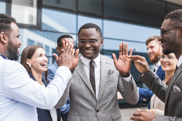 Portrait of an handsome businessman in front of his team. recognition, movement on the career ladder, success in business