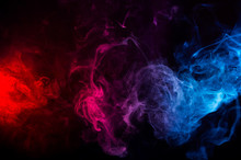 Abstract Shapes Of Mixed Colors Of Blue And Red Smoke At Dark Background
