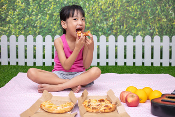 Asian Chinese little girl Eating Pizza