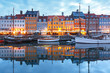 Panorama of north side of Nyhavn with colorful facades of old houses and old ships in the Old Town of Copenhagen, capital of Denmark.
