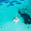 Drone aerial view of catamaran sailing boat in Maddalena Archipelago, Sardinia, Italy. Maddalena Archipelago is a group of islands between Corsica and north-eastern Sardinia.