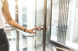 © xartproduction - woman pressing elevator button. finger presses elevator button. businessman in lift