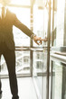 © xartproduction - Man pressing elevator button. finger presses elevator button. businessman in lift