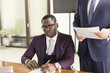 © xartproduction - African american man signing contract, black man hand putting signature on official document, biracial clients customers couple make purchase or sign prenuptial agreement concept