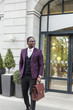© xartproduction - stylish businesswoman with briefcase on city background. African American man talking on mobile phone